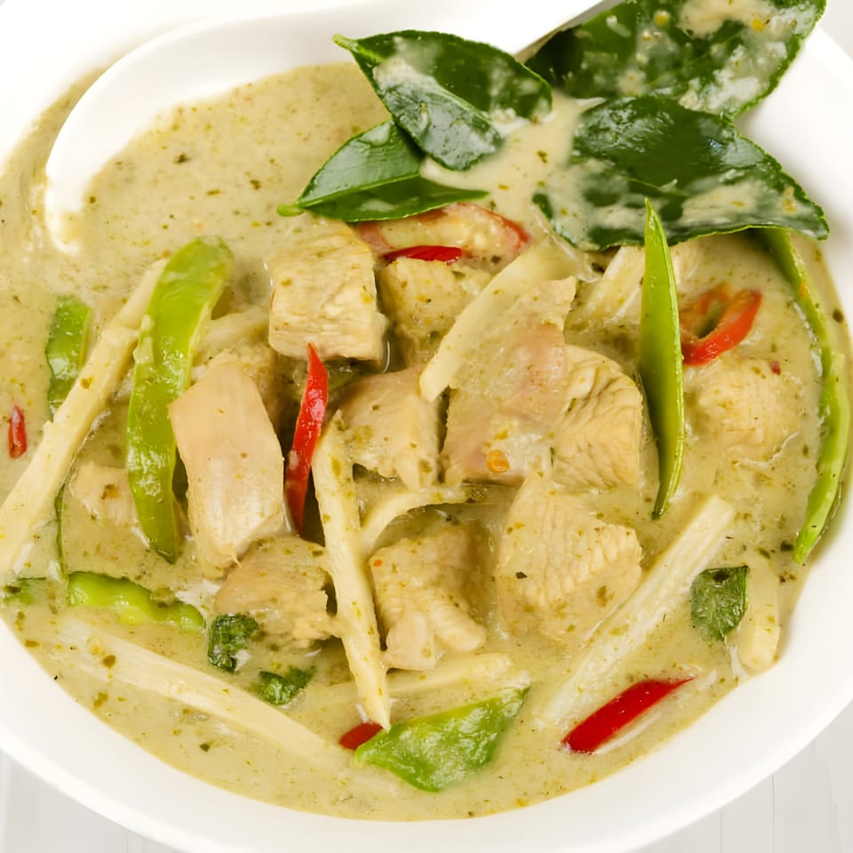 Close-up of West Covina Thai Cuisine's green curry with chicken, bamboo shoots, and red peppers.