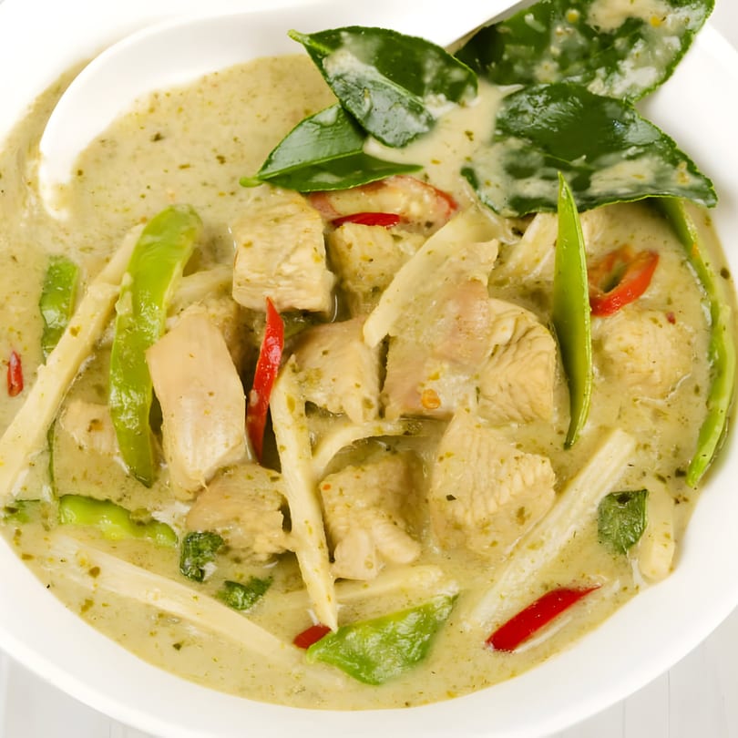 Close-up of West Covina Thai Cuisine's green curry with chicken, bamboo shoots, and red peppers.